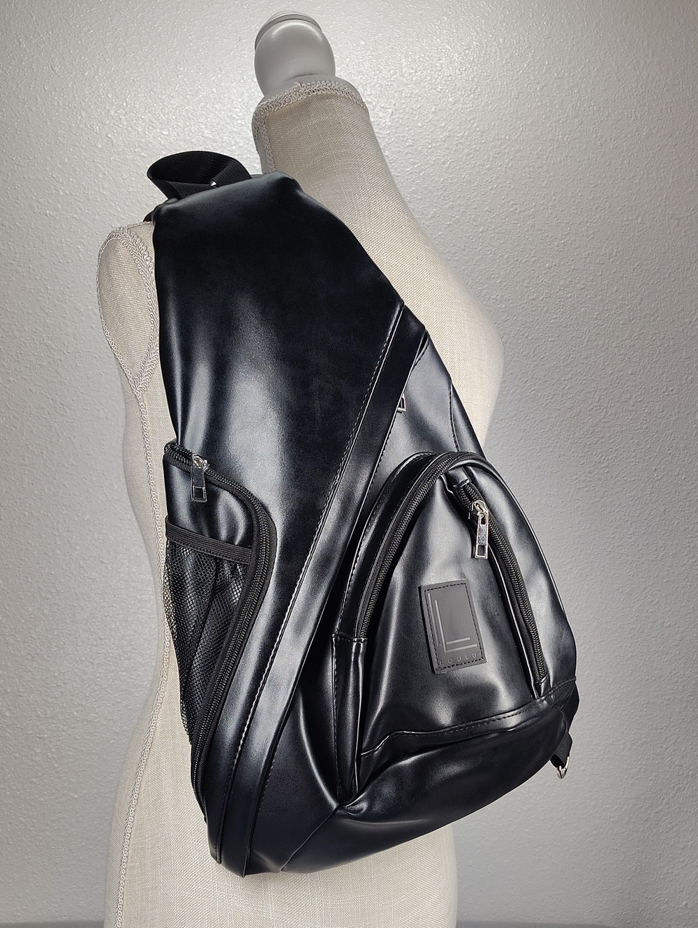 Loulu brand faux leather sling backpack